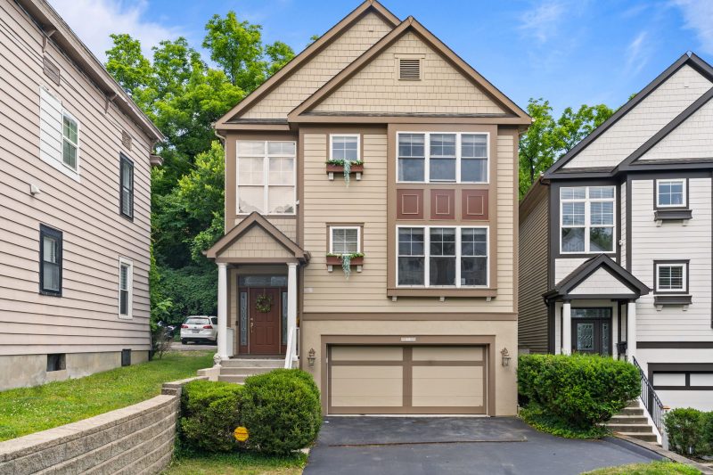 Modern suburban home in Cincinnati, Ohio, featuring a garage and a well-maintained garden.